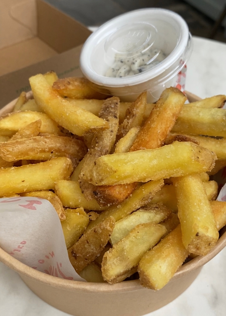crispy skin on fries in a cardboard tub